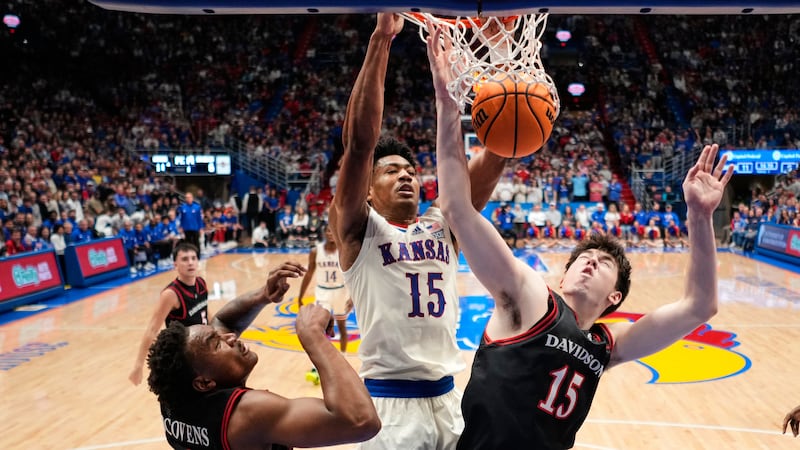 Kansas forward Bryson Tiller (15) dunks the ball over Davidson forward Sean Logan, right,...